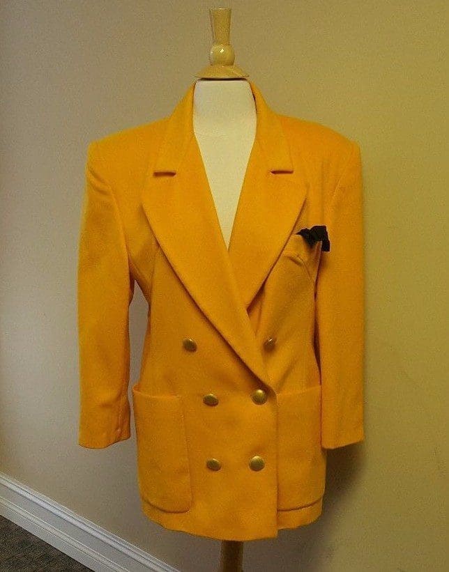 Yellow double-breasted blazer on mannequin.