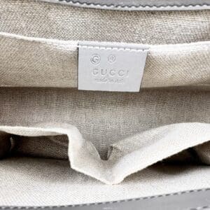 Gucci handbag interior with label tag.