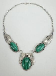 Silver necklace with green stone pendants.