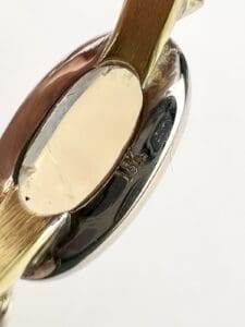 Close-up of metallic bracelet with engraving.