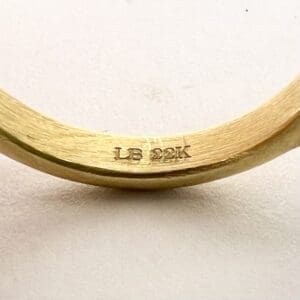 Gold ring with "LB 22K" engraving.