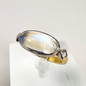 Oval moonstone ring with gold band.
