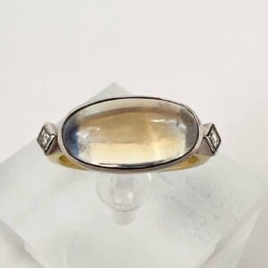 Oval gemstone ring with silver band.