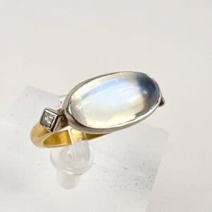 Gold ring with large oval gemstone.