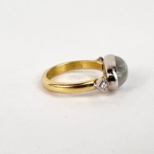 Gold ring with large round gemstone.