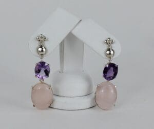 Silver earrings with pink and purple stones.