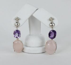 Purple and pink gemstone dangle earrings display.