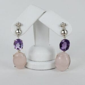 Purple and pink gemstone dangle earrings display.