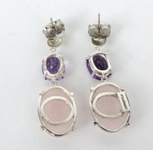 Silver earrings with purple and pink stones.