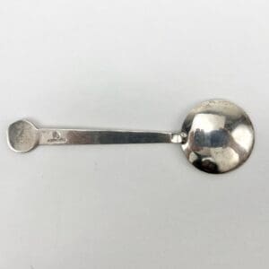 Silver spoon on a white background.