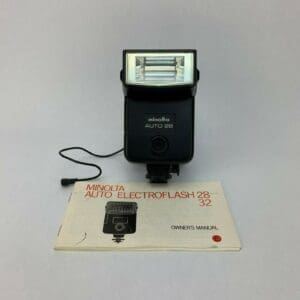 Minolta camera flash with owner's manual.