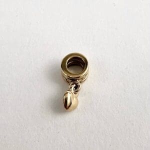 Gold charm with a small dangling bead.