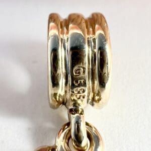 Gold ring with engraved markings and chain.
