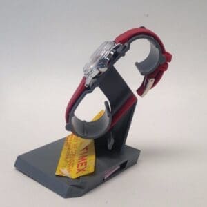 Red wristwatch on a display stand.