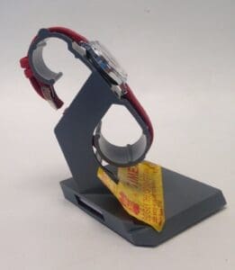 Red-banded watch on a display stand.