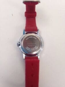 Watch back with red leather strap.