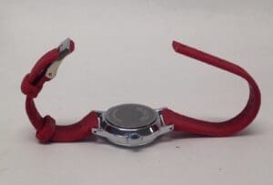 Red wristwatch with silver case, unclasped.