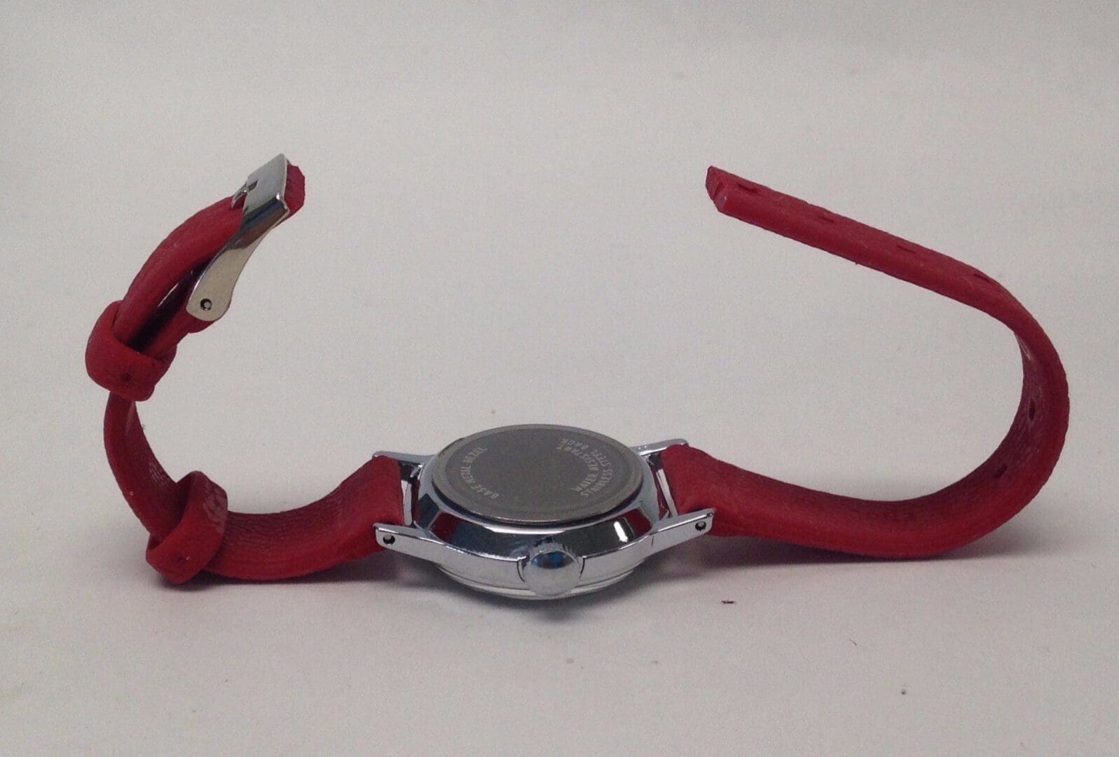 Red wristwatch with silver case, unclasped.