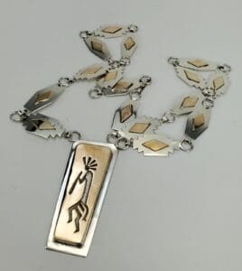 Silver and gold necklace with tribal design.