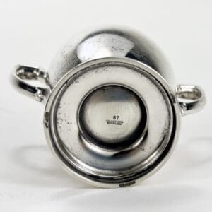 Bottom view of a silver metal cup.