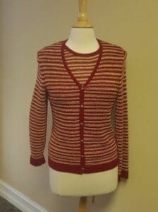 Red and white striped cardigan on mannequin.