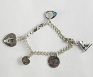 Silver charm bracelet with various pendants.