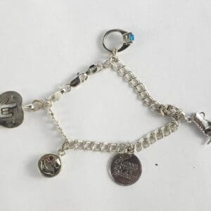 Silver charm bracelet with various pendants.