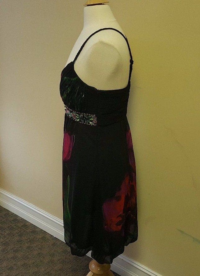 Side view of floral dress on mannequin.