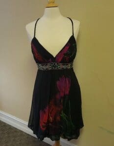 Black floral dress on a mannequin.