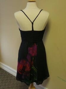 Back view of black floral dress mannequin.