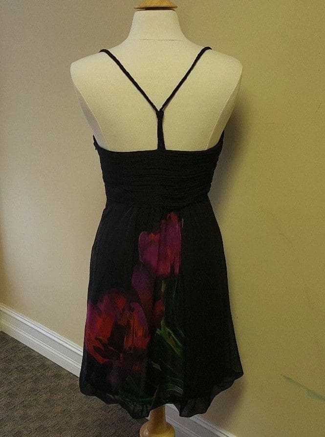 Back view of black floral dress mannequin.