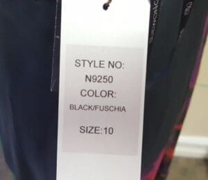 Clothing tag with style, color, size details.