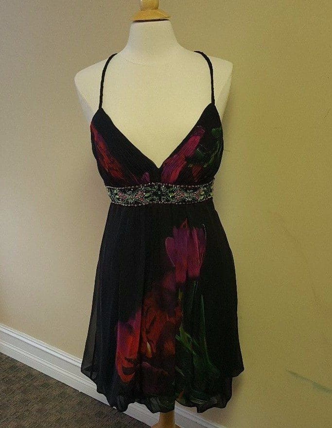 Black floral dress on a mannequin.