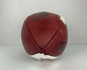 Deflated American football on white background.