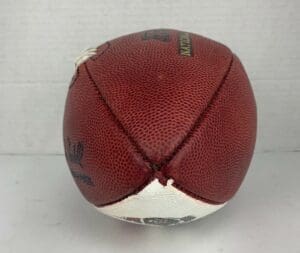 Deflated brown leather American football ball.