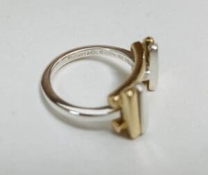 Gold and silver ring with engraved details.