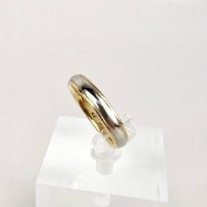 Gold and silver ring on display stand.
