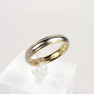 Gold and silver wedding band on display.
