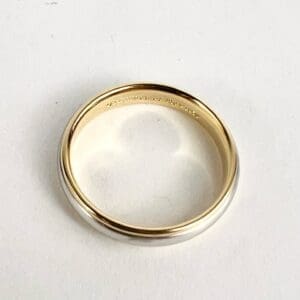 Gold and silver ring on white background.