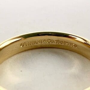 Gold ring with Tiffany & Co. engraving.