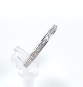 Silver ring with embedded small diamonds.