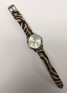 Silver watch with animal print strap.