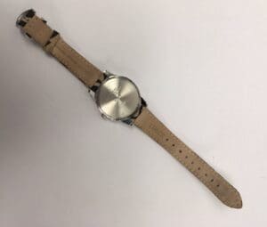 Wristwatch with leather strap, back view.