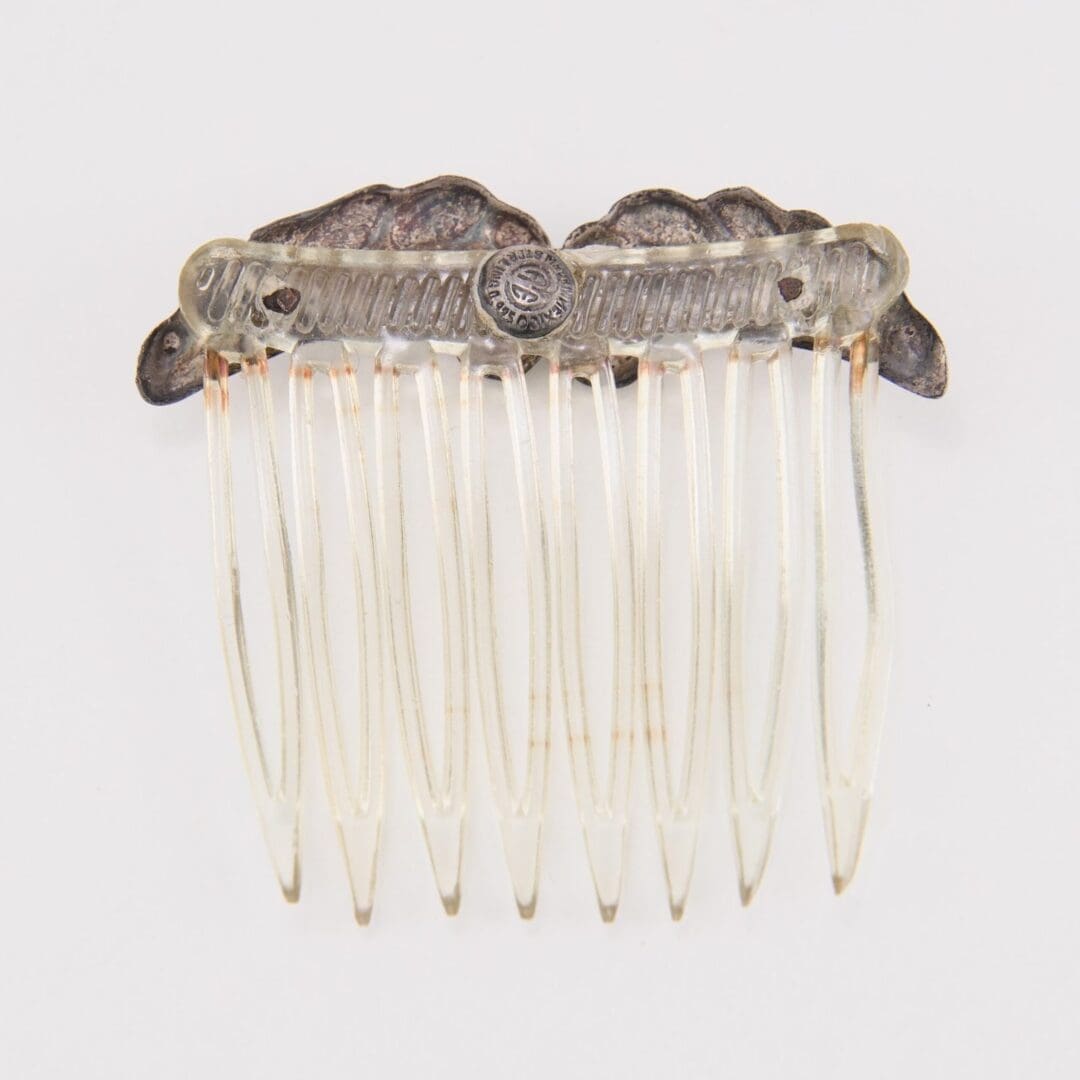 Ornate vintage hair comb with metal detailing.