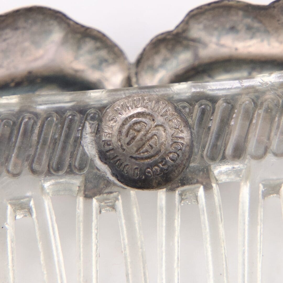 Metal and plastic vintage hair comb close-up.