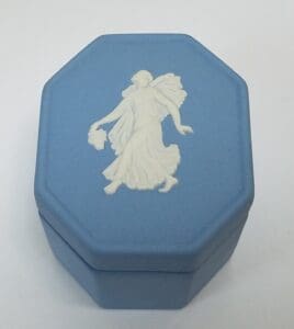 Blue octagonal box with white relief figure.