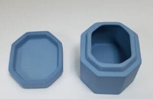 Blue octagonal container with lid removed.