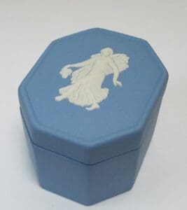 Blue hexagonal box with white figurine design.