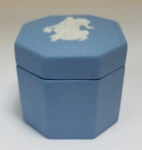 Blue octagonal box with white embossed design.