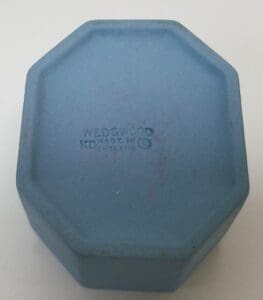 Blue octagonal Wedgwood box with stamped text.